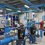 An equipment room of the water treatment plant with various pipes.
