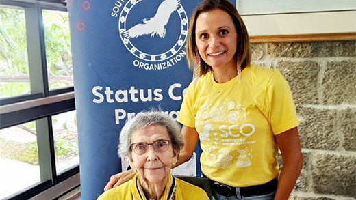 Two people sharing a smile during a community gathering.